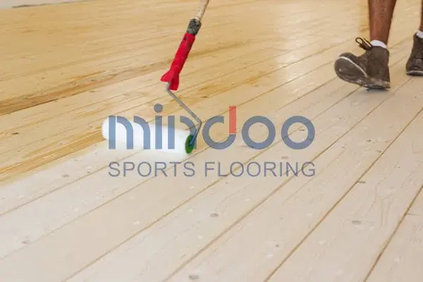 Sports wood flooring being painted Sports wood flooring being painted