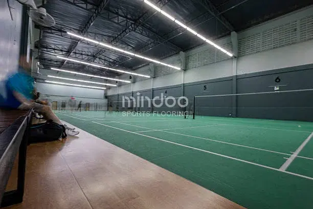 Clean and tidy wooden floor of the badminton court.